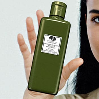 woman holding a green bottle